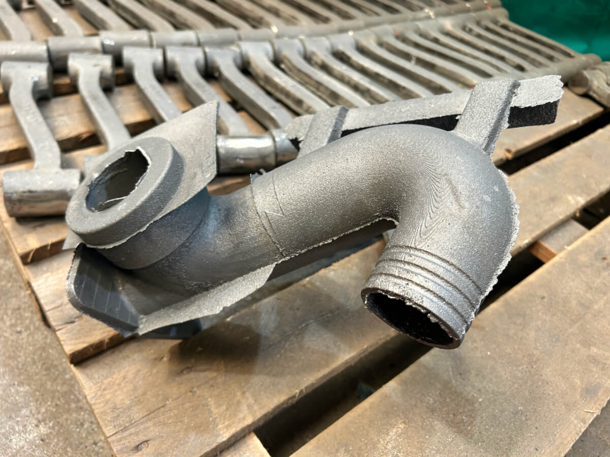 As-cast swan neck component prior to finishing