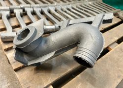 As-cast swan neck component prior to finishing As-cast swan neck component prior to finishing